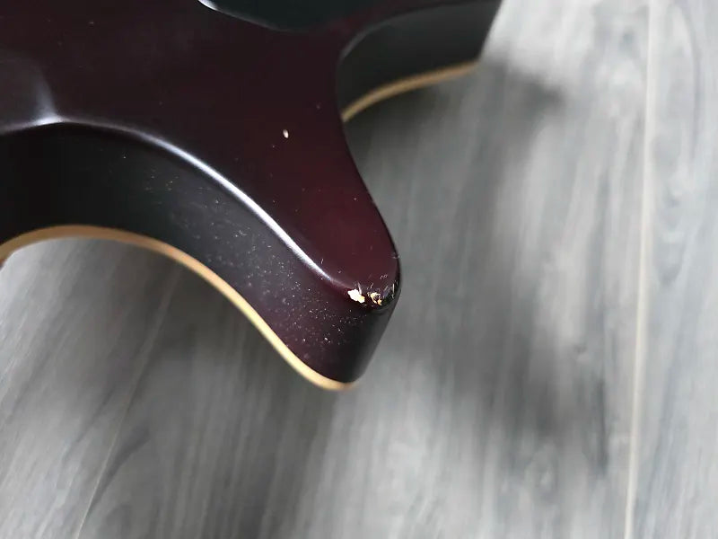 Close-up of a small scuff mark on an electric guitar