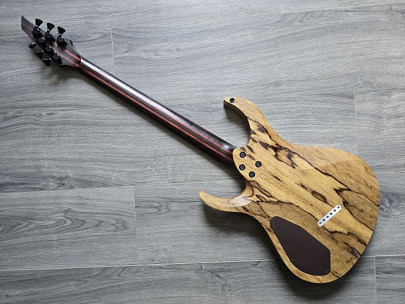 Wooden electric guitar on a gray surface